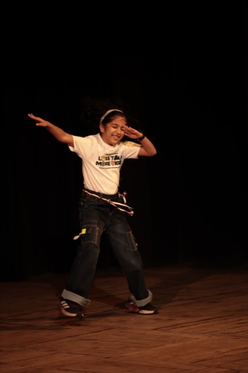 A child performing to a live audience